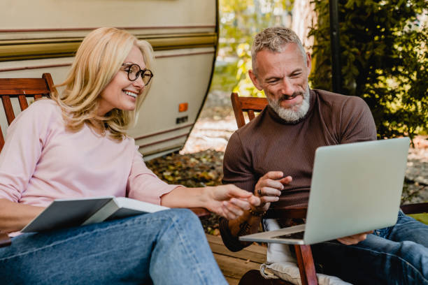 man and woman using computers