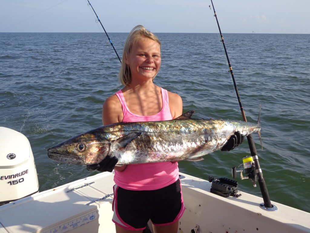 girl holding large fish